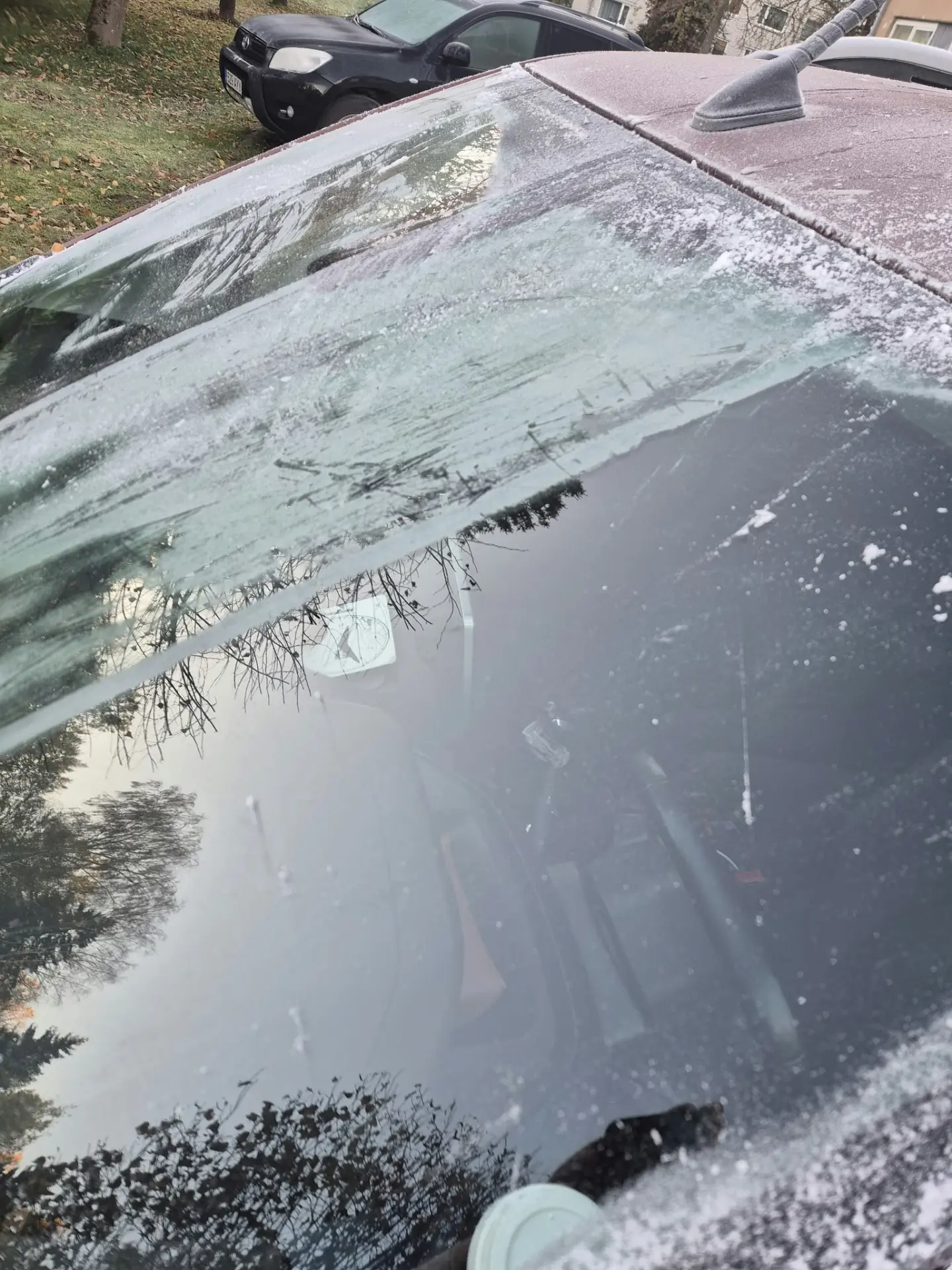 Real winter photo of a frosted car windshield where the treated area cleared far faster than the rest of the glass